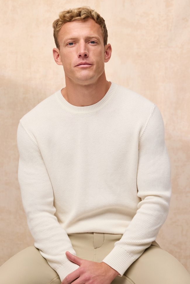image of a man sitting wearing a white tech linen crew sweatshirt