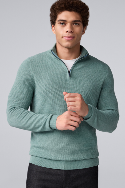 image of a man wearing a green tech linen half zip